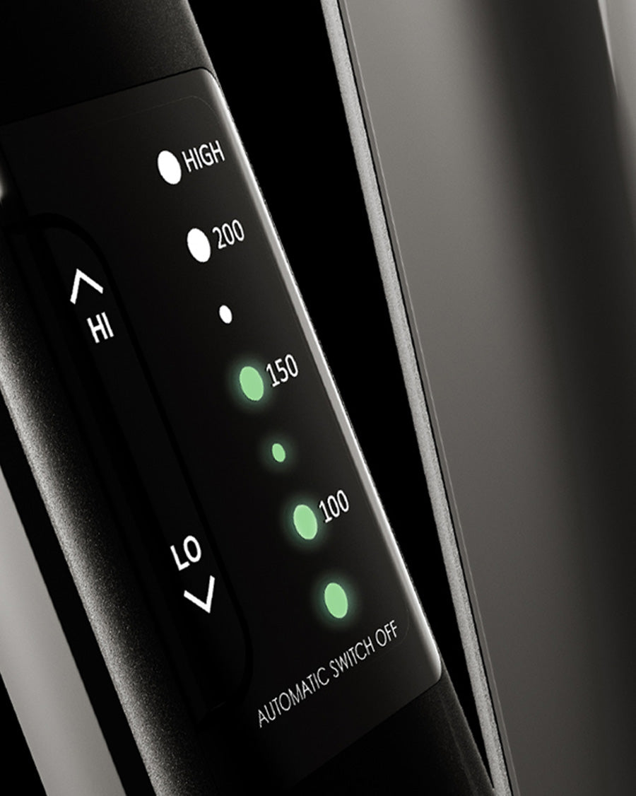 Close-up of the variable temperature control panel on a black CLOUD NINE straightener on a black background. 